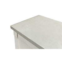 Close-up of gray top on white sideboard.