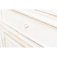 Close-up drawer detail on white display cabinet, knob visible.