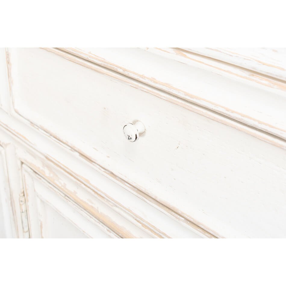 Close-up drawer detail on white display cabinet, knob visible.