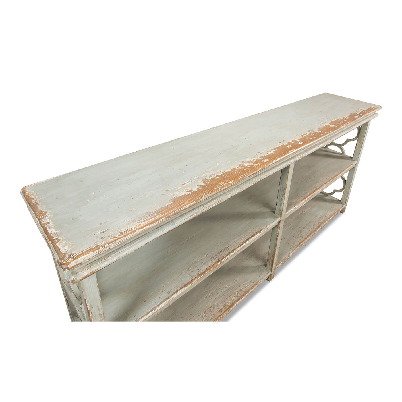 Top angle of country painted quatrefoil bookcase shelves.