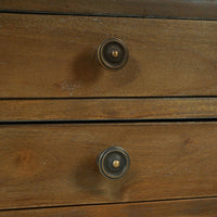 Close-up of knobs on wooden side table drawers.