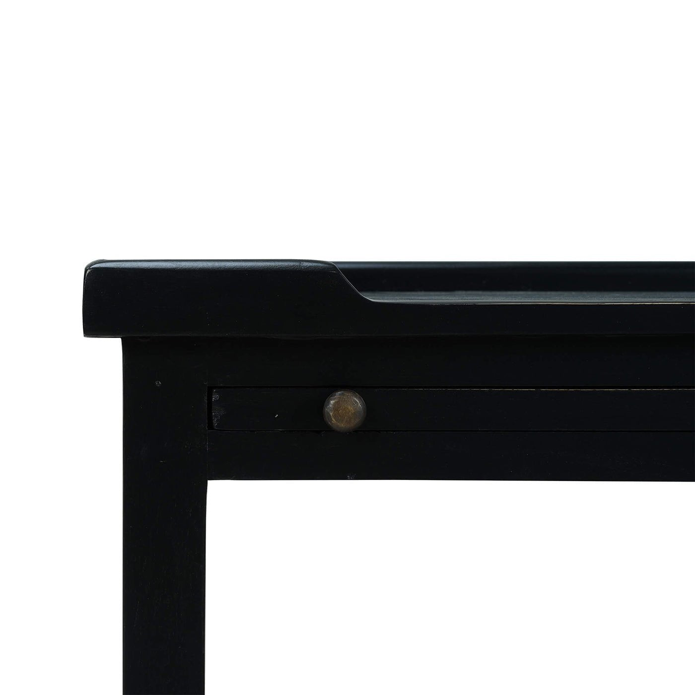 Close-up of black side table corner and drawer detail.