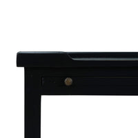 Close-up of black side table corner and drawer detail.