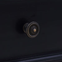 Close-up knob detail on black end table drawer.
