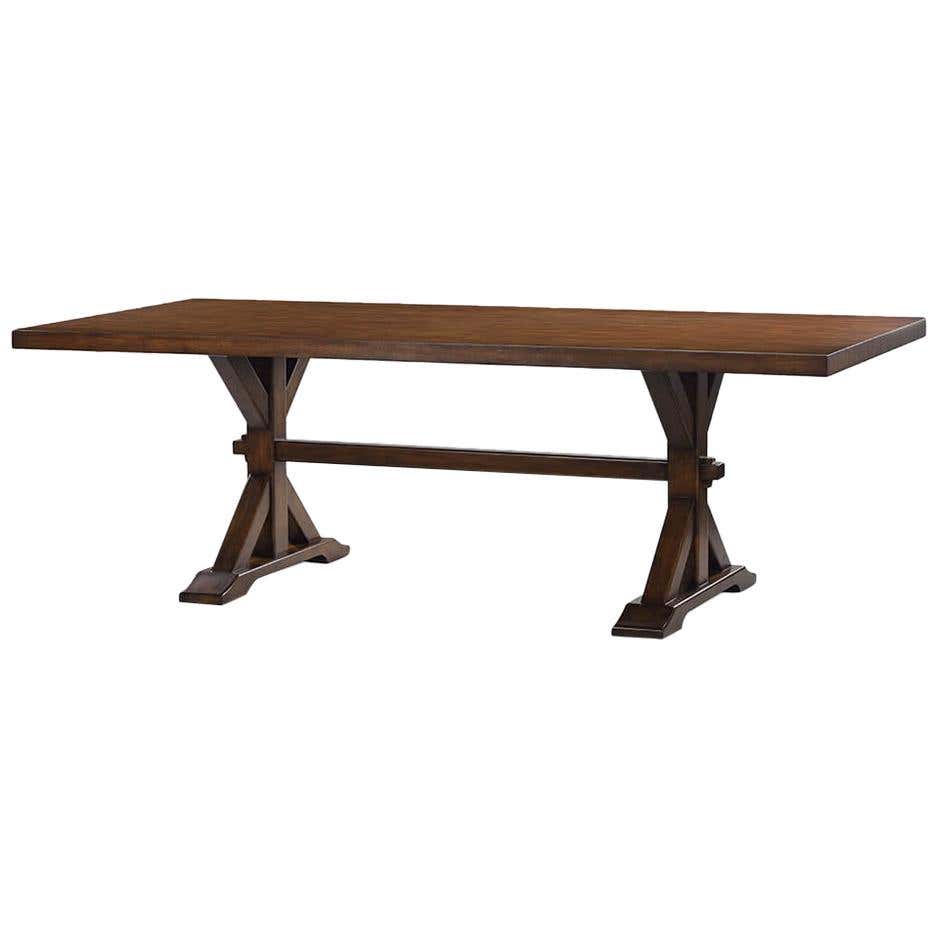 Wooden trestle dining table angled view.