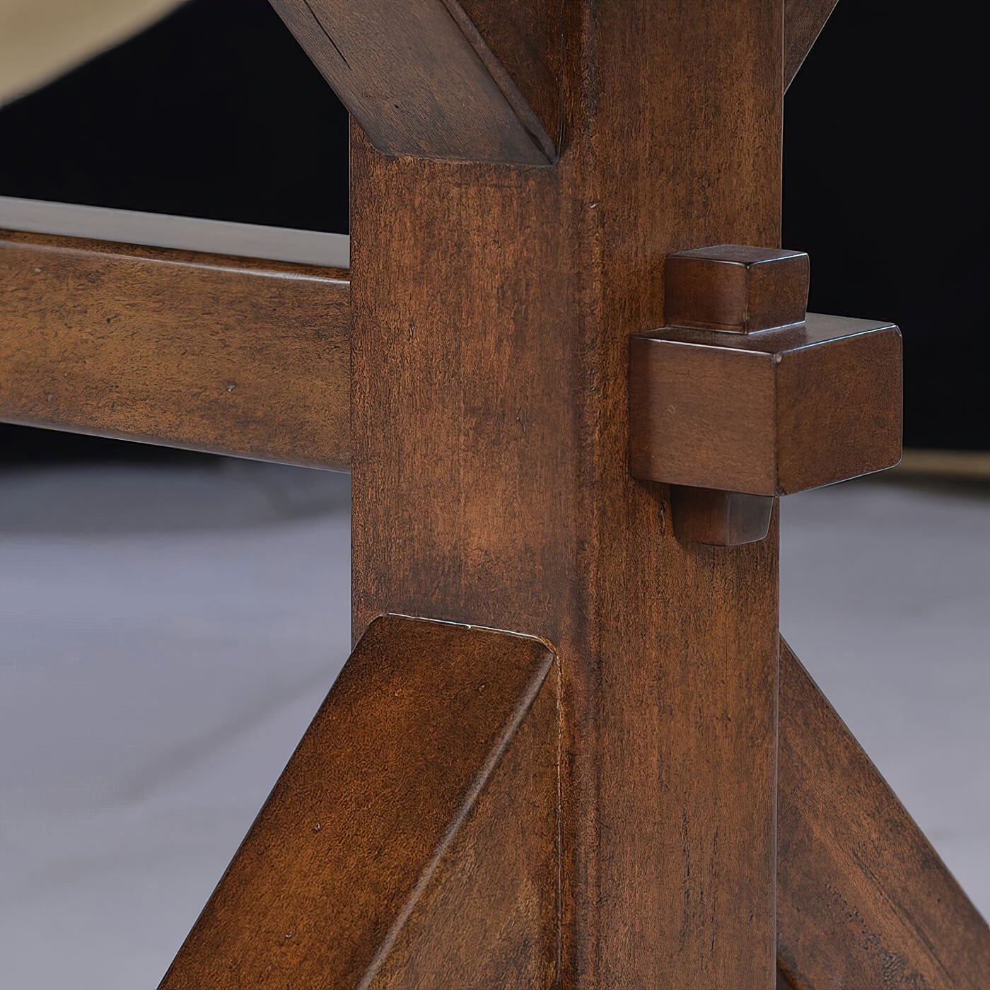 Close-up of trestle joint on rustic dining table.