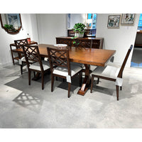 Dining table with chairs, showroom setting, polished concrete floor.