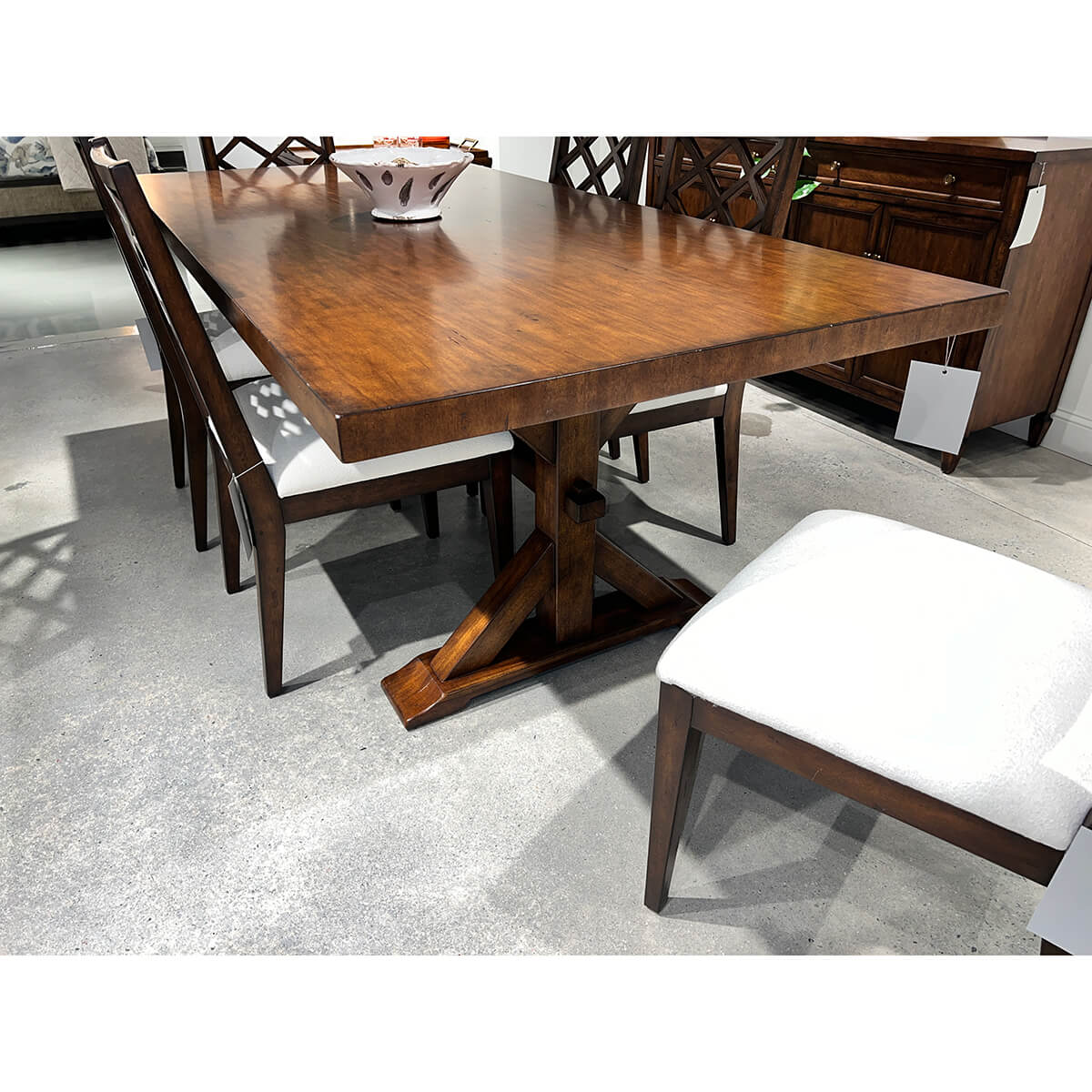 Rustic dining table with chairs, close-up view in showroom.