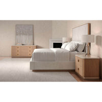 Bedroom with cream upholstered king bed side view