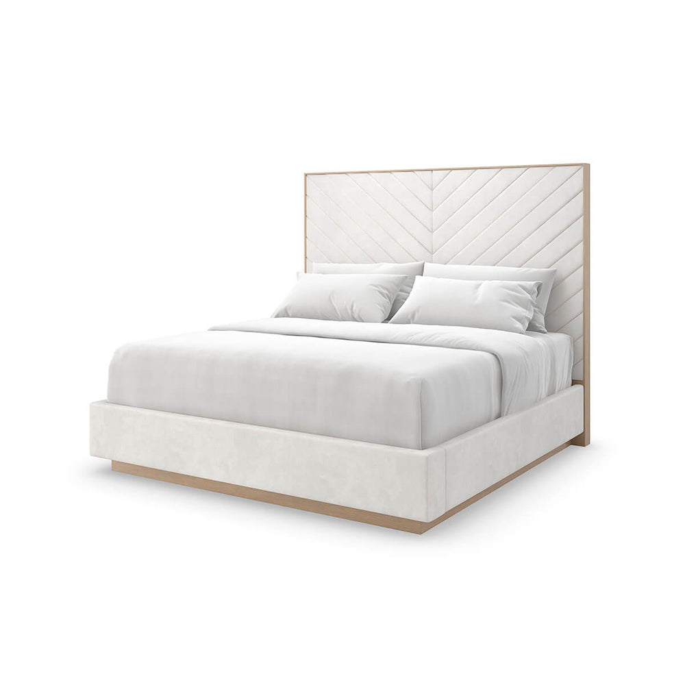 Cream chevron tufted upholstered queen bed, angled view.