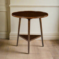 Wooden side table beside a wall, light wood floor.