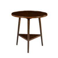 Round wooden side table on white background.