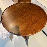 Top view of wooden side table, smooth round surface.