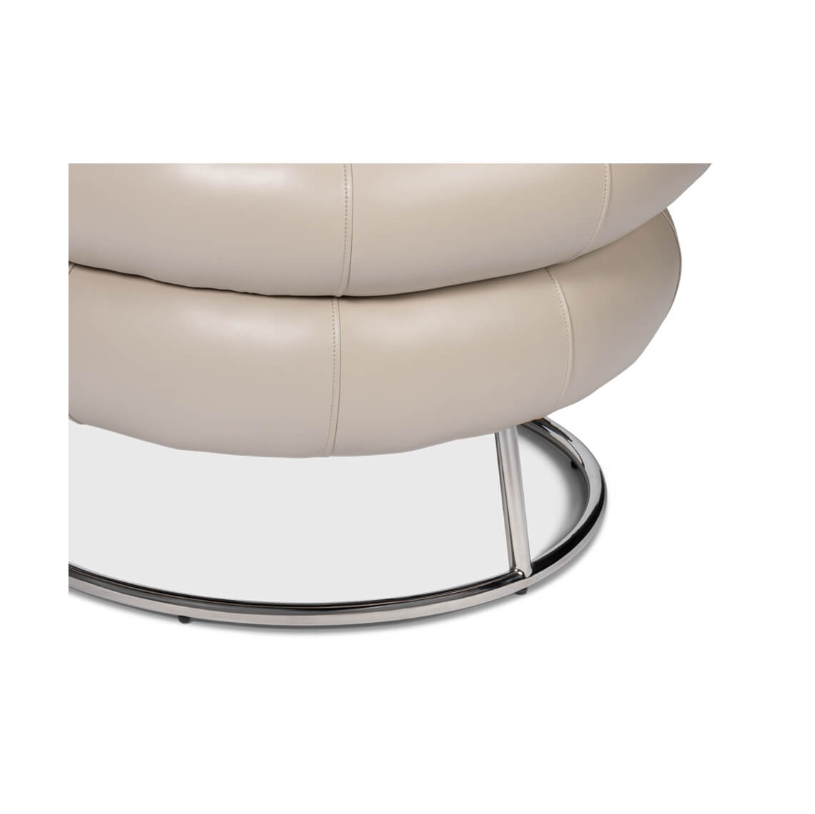 Chrome base detail of leather accent chair.