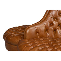 Sofa armrest and tufted pattern detail.