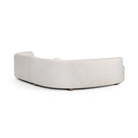 Rear view of ivory bouclé sectional showing the continuous curve of its upholstered back