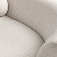 Close-up of the ivory bouclé sectional seat and curved inner back