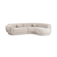 Angled front view of cream two-piece curved sectional with rounded arms and two round accent pillows