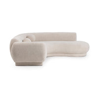 Opposite angled view of cream sectional showing the thick rounded arm and curved seating