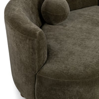 Close-up of olive green sectional arm and seat with a round accent pillow