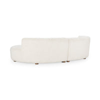 Rear view of cream curved sectional showing the upholstered back, center join and short wood feet