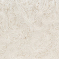 Close-up of the cream sectional fabric showing its fluffy, long-pile texture