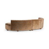 Rear view of brown curved sectional showing the upholstered back, center join and low wood feet