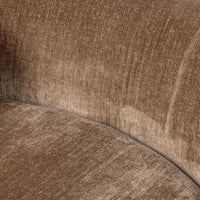 Close-up of the brown sectional where its textured seat and curved back meet