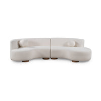 Front view of ivory two-piece curved sectional with round accent pillows and low round wood feet