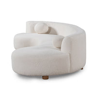 Side-angle view of ivory curved sectional with rounded ends, textured upholstery and round wood feet