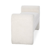 End view of the ivory textured upholstered bench showing a broad rounded support and the seat between its arms