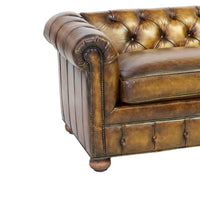 Close-up Chesterfield sofa arm, detailed tufting, leather finish.