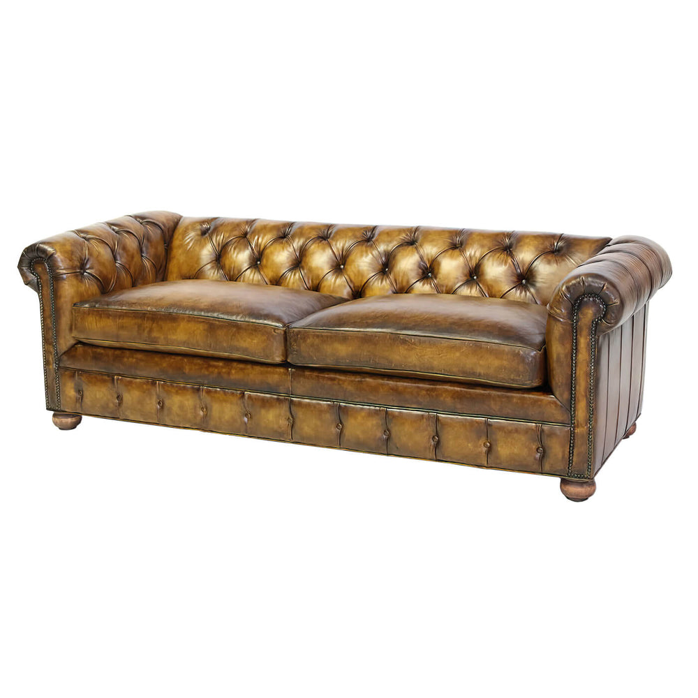 Chesterfield leather sofa, front view, tufted design.
