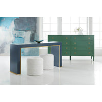Styled blue console table with decor in bright room