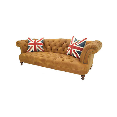 Brown tufted sofa with Union Jack pillows.