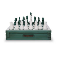Front view of green chess board with white, green pieces.