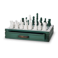 Wooden chess set with partially opened storage drawer.