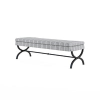 Charcoal striped upholstered bench on burnished brass metal legs, angled view