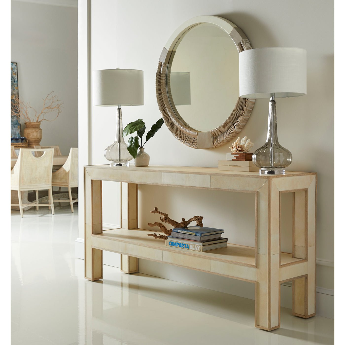 Hallway setup with round mirror and console table.
