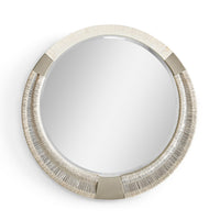 Round decorative mirror with braided frame, close-up view.