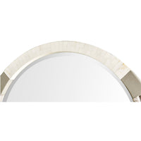 Close-up of round mirror's top braided and metal accents.