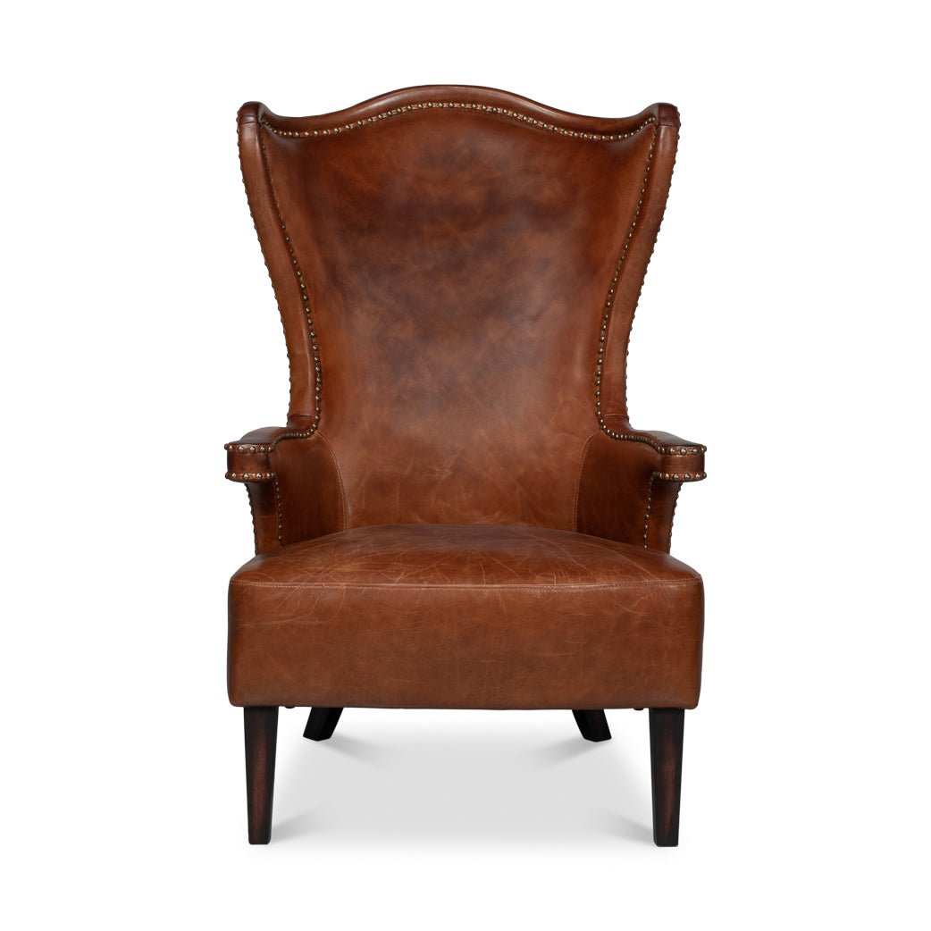 Front view of dark brown high back leather wing chair.