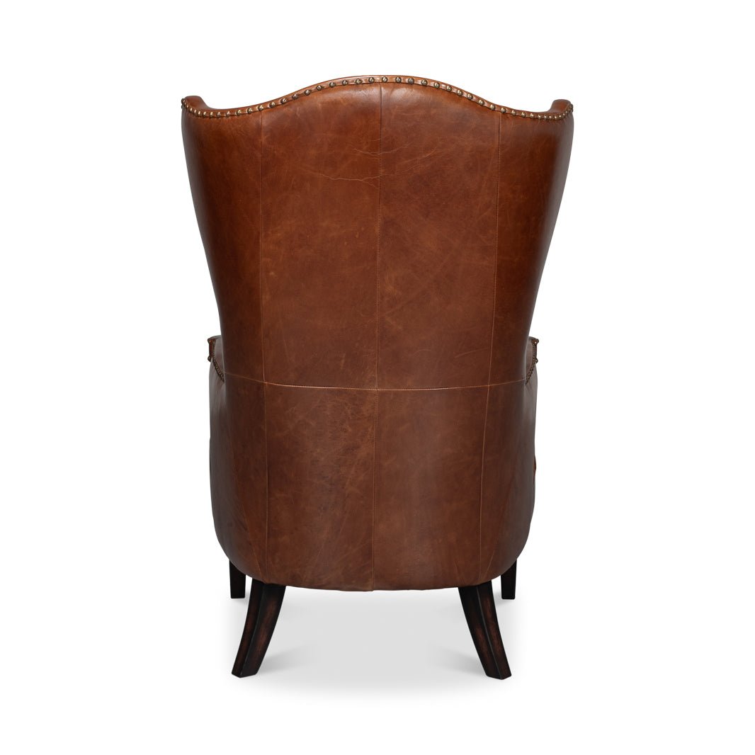 Rear view, dark brown high back leather wing chair.