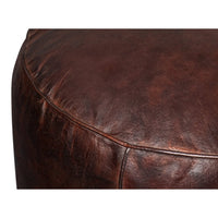 Detailed close-up of leather texture on stool.