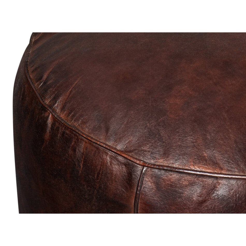 Detailed close-up of leather texture on stool.
