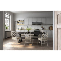 Dining table styled in modern kitchen setting.