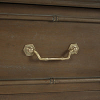 Handle detail of faux bamboo end table drawer.