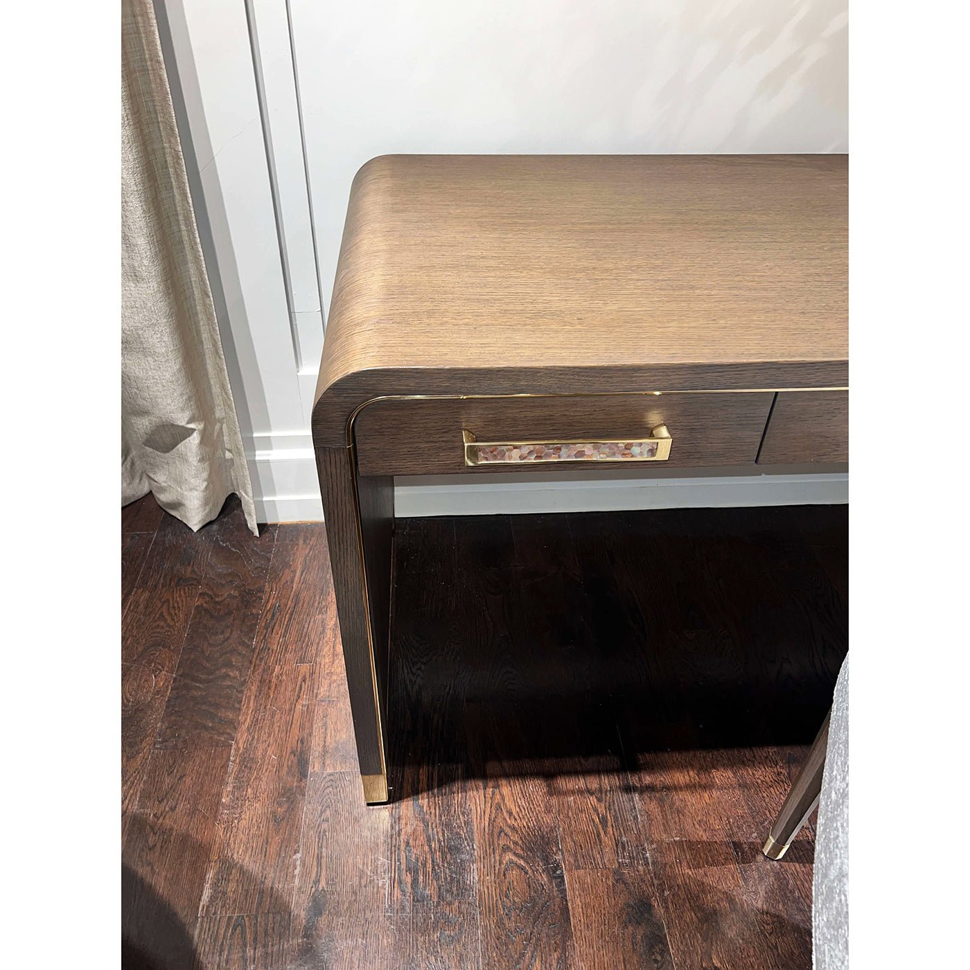 Detailed view of desk corner and handle design features.