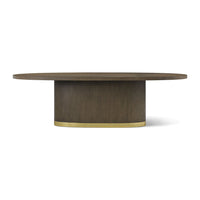 Front view of oval dining table with brass detail.