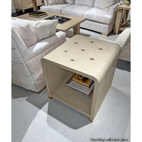 Beige side table in decorated living room.